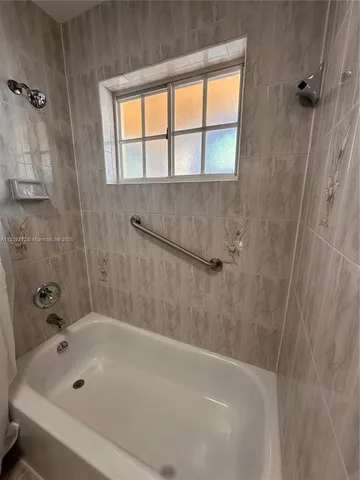 a bathroom with a tub and a shower