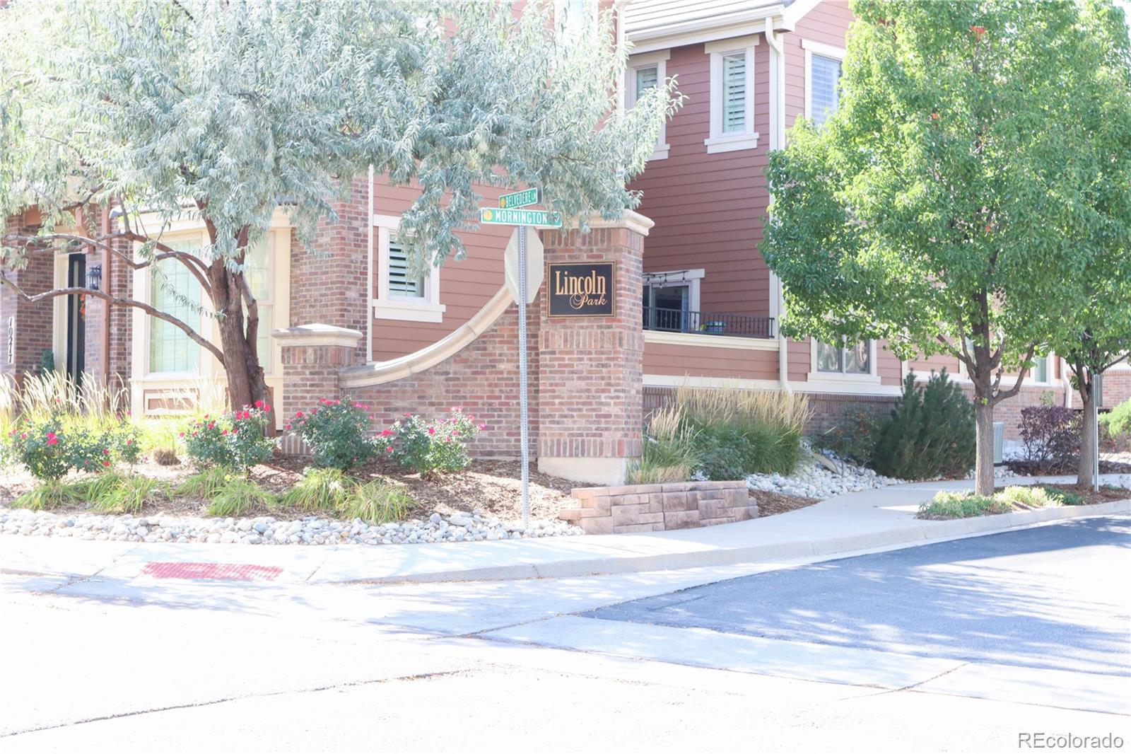 9242 Ridgegate Parkway Lone Tree, CO 80124 - Photo 26 of 28 a front view of a house with a yard and potted plants
