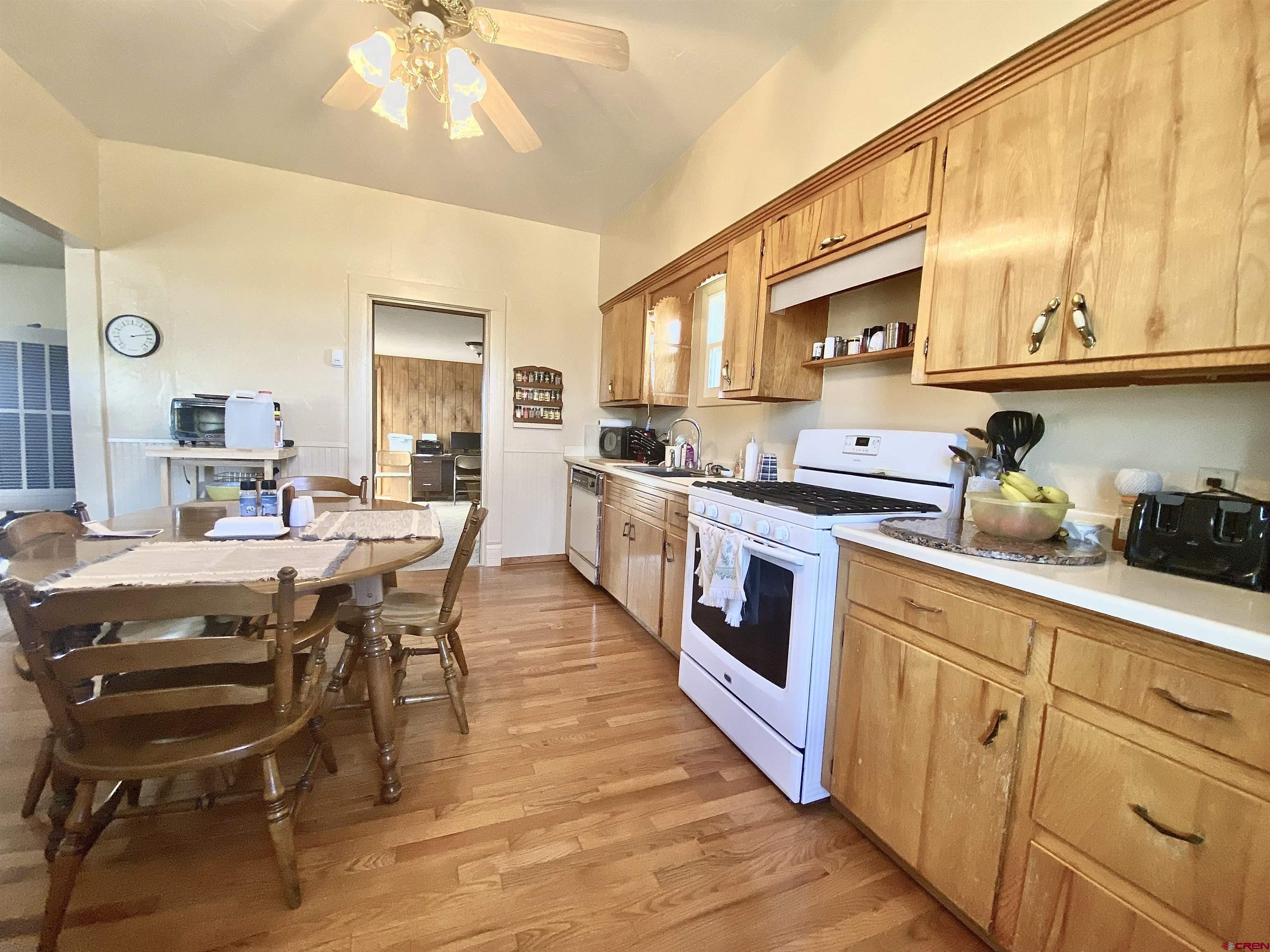 15689 2525th Road Cedaredge, CO 81413 - Photo 8 of 33 a kitchen with stainless steel appliances a stove a sink a dining table and chairs