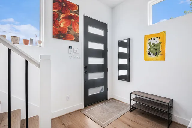a living room with furniture and baby area