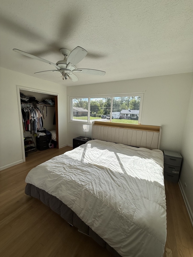4326 151st Street Midlothian, IL 60445 - Photo 14 of 26 a bedroom with a large bed and a chandelier