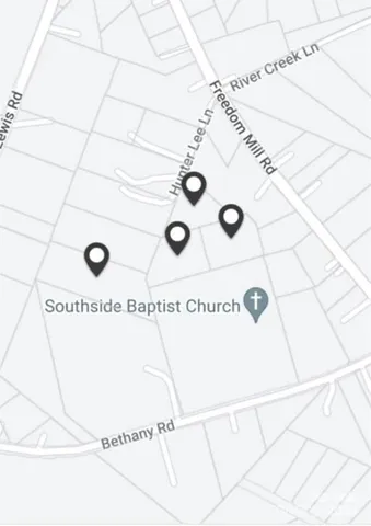 a view of lake with houses in background