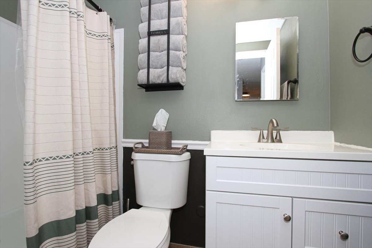 2300 Old Tavern Road, Unit 203 Lisle, IL 60532 - Photo 18 of 26 a bathroom with a toilet sink and mirror