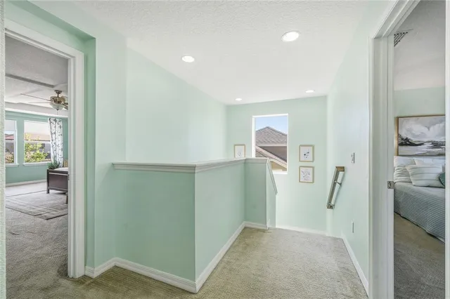 a bedroom with a large bed couch and a large window
