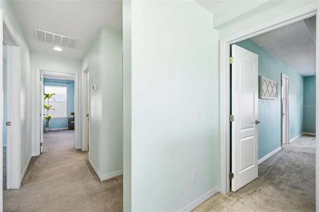 a bedroom with a bed and a potted plant