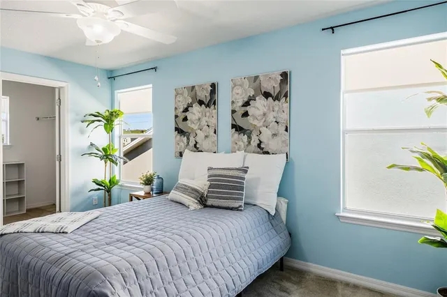 a view of a room with window and ceiling fan