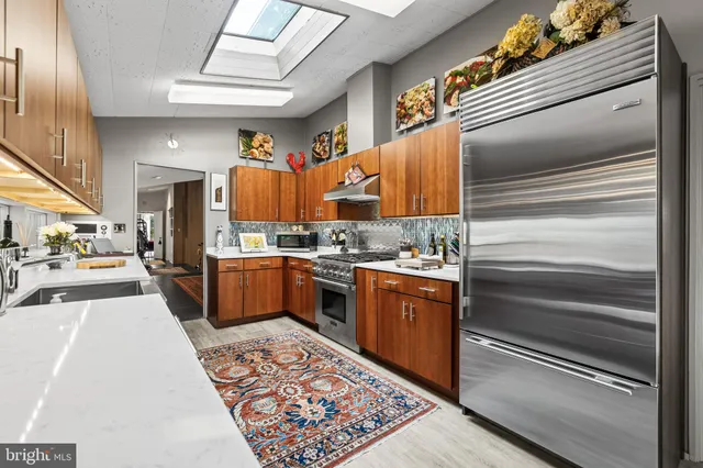 a outdoor dining space with furniture and a chandelier