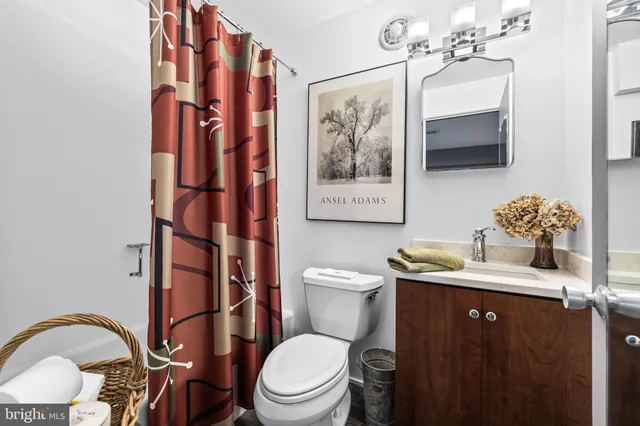 an outdoor sitting area with couch and wooden fence