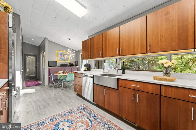 a kitchen view with stainless steel appliances kitchen island granite countertop a refrigerator and a stove