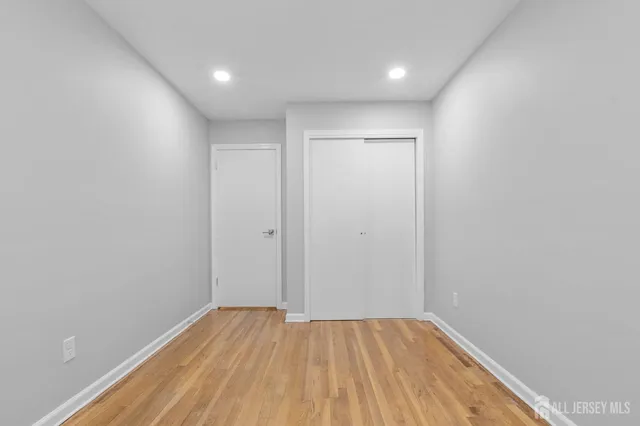 a view of room with wooden floor