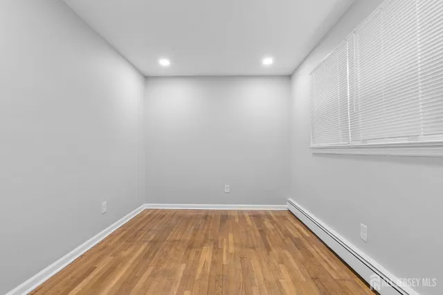 a view of room with wooden floor and fan