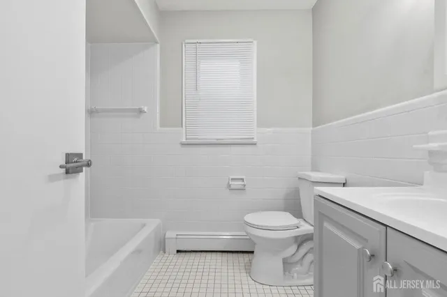 a bathroom with a toilet a sink and bathtub