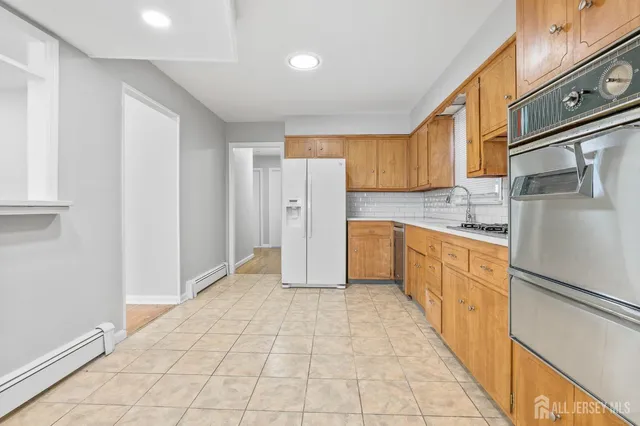 a kitchen with stainless steel appliances a refrigerator and a stove