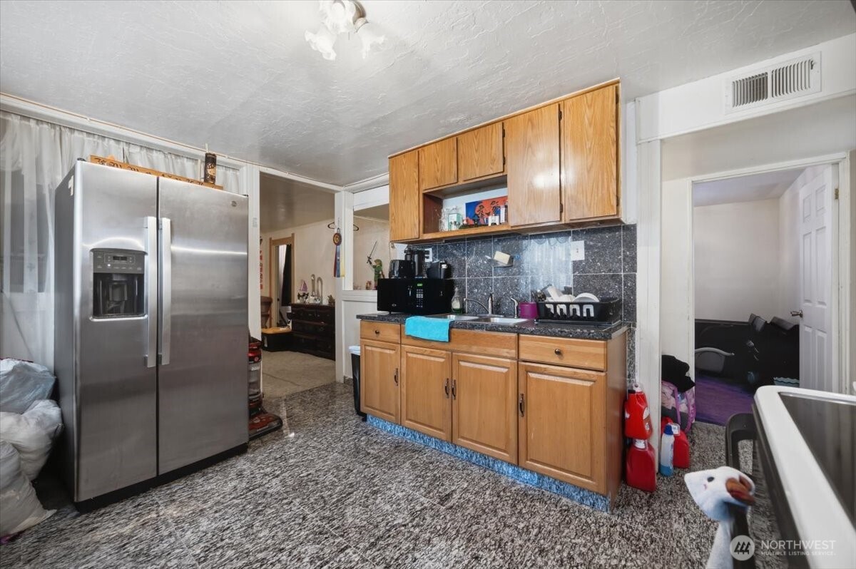 802 South 11th Avenue Pasco, WA 99301 - Photo 14 of 24 a kitchen with stainless steel appliances granite countertop a refrigerator a stove and a sink with cabinets