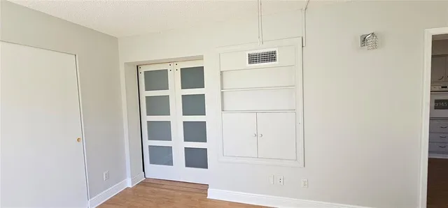 a view of an empty room with cabinet