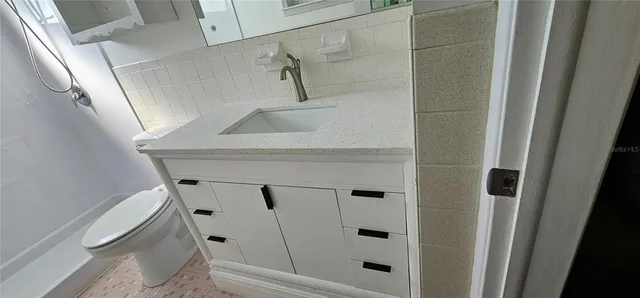 a bathroom with a shower and toilet