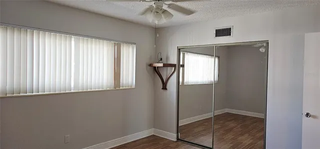 a kitchen with stainless steel appliances white cabinets and a refrigerator