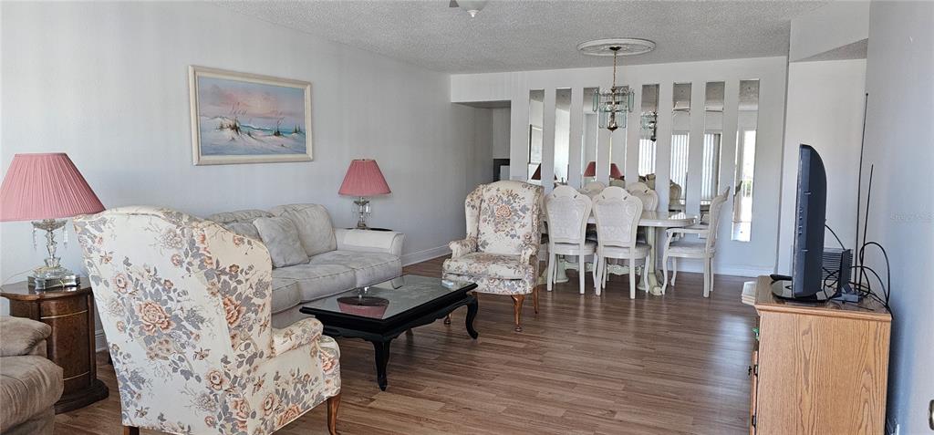 2450 Canadian Way, Unit 26 Clearwater, FL 33763 - Photo 4 of 32 a living room with furniture and a flat screen tv