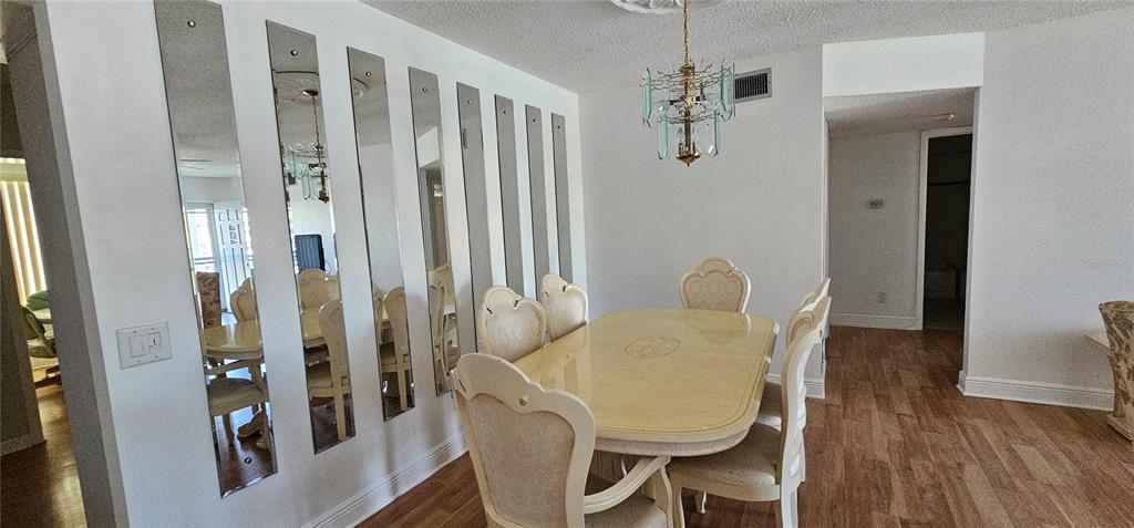 2450 Canadian Way, Unit 26 Clearwater, FL 33763 - Photo 5 of 32 a view of a dining room with furniture and wooden floor