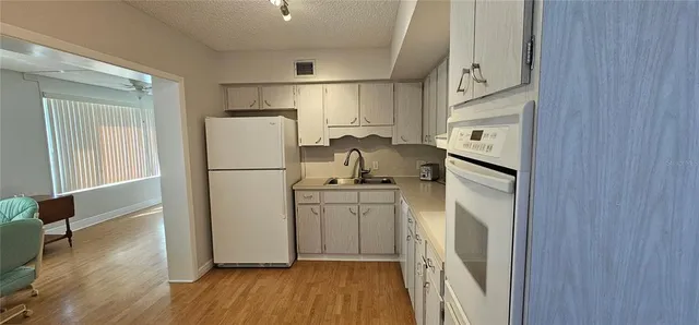a kitchen with a refrigerator a sink and dishwasher