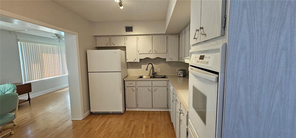 2450 Canadian Way, Unit 26 Clearwater, FL 33763 - Photo 6 of 32 a kitchen with a refrigerator a sink and dishwasher