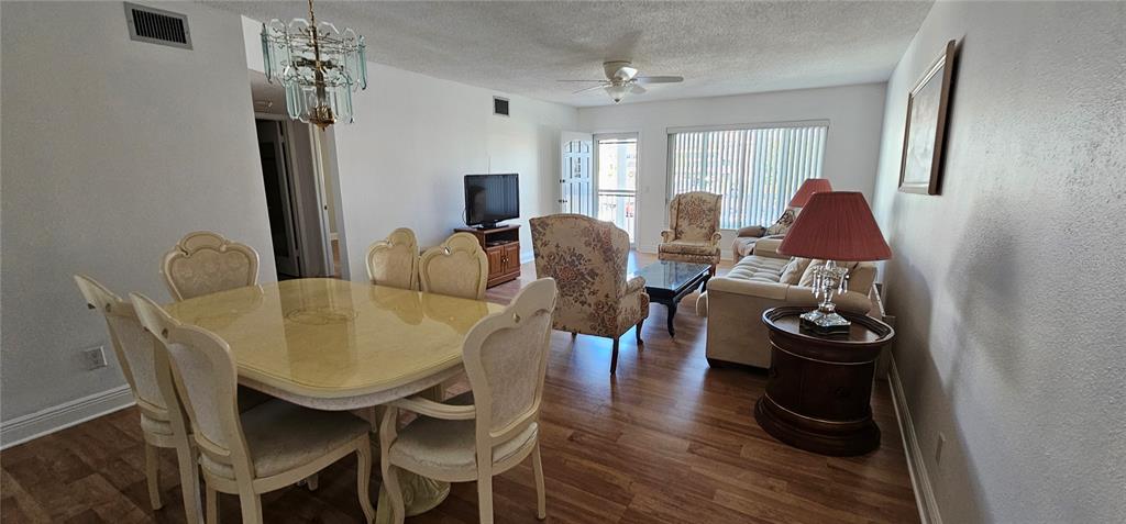 2450 Canadian Way, Unit 26 Clearwater, FL 33763 - Photo 7 of 32 a dining room with furniture and wooden floor