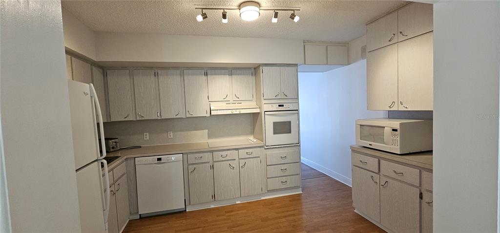 2450 Canadian Way, Unit 26 Clearwater, FL 33763 - Photo 8 of 32 a kitchen with cabinets stainless steel appliances and a sink