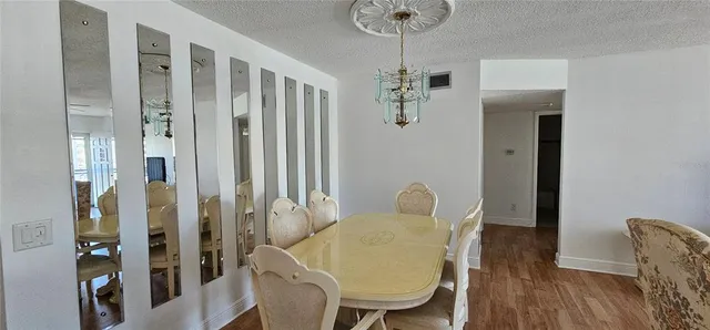 a view of a room with furniture and wooden floor
