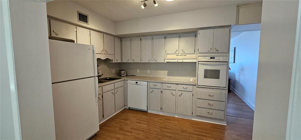 2450 Canadian Way, Unit 26 Clearwater, FL 33763 - Photo 10 of 32 a kitchen with stainless steel appliances granite countertop a refrigerator sink and cabinets