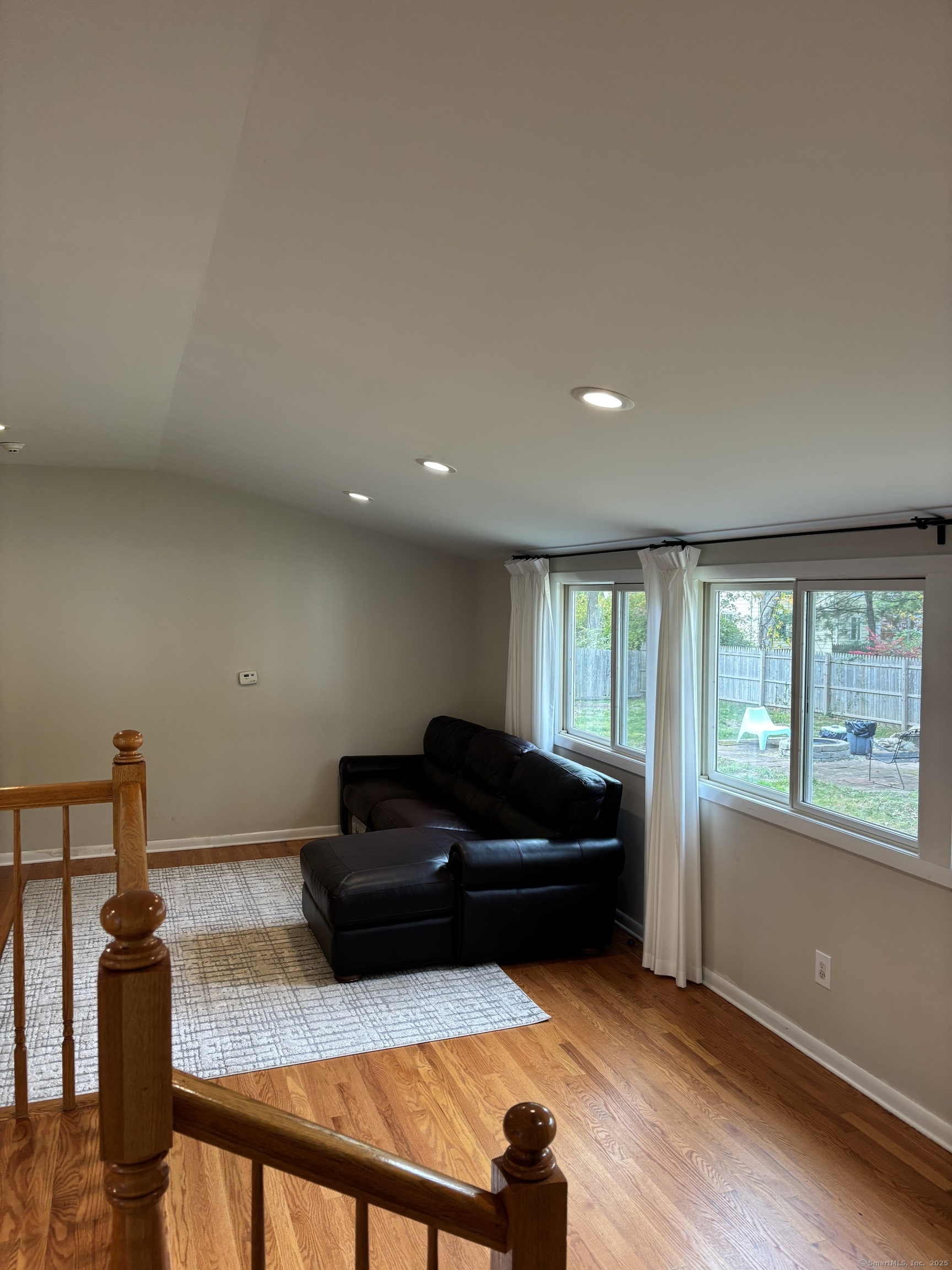 846 Beechwood Road Orange, CT 06477 - Photo 11 of 25 a living room with furniture and a flat screen tv