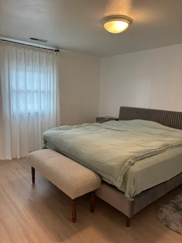 a bedroom with a bed and lamps