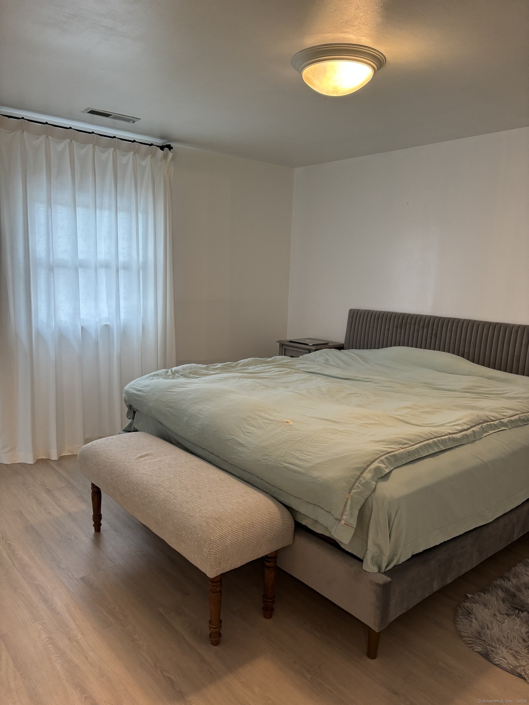 846 Beechwood Road Orange, CT 06477 - Photo 13 of 25 a bedroom with a bed and lamps