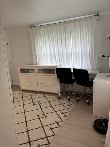 a living room with a furniture and a window