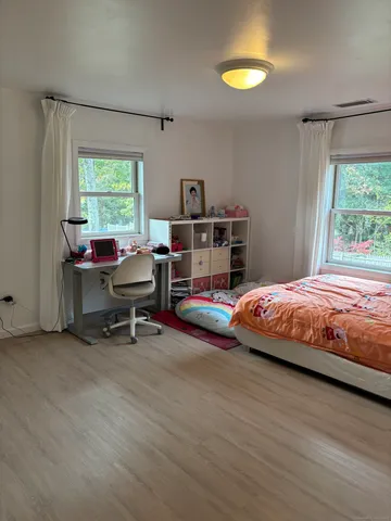 a bedroom with a bed and a window