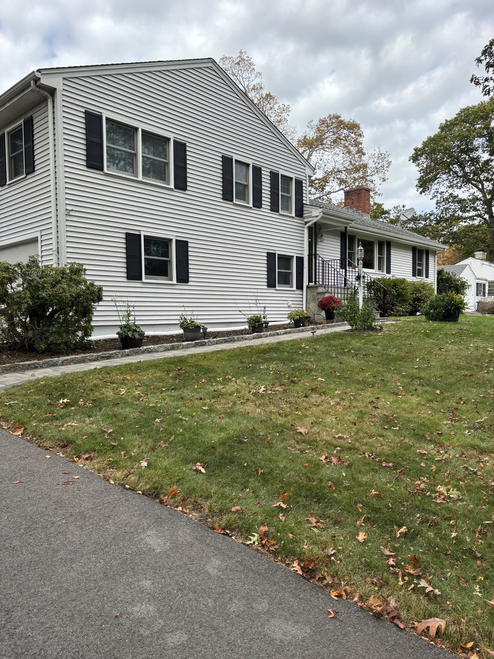 846 Beechwood Road Orange, CT 06477 - Photo 2 of 25 a view of a house with a big yard and potted plants