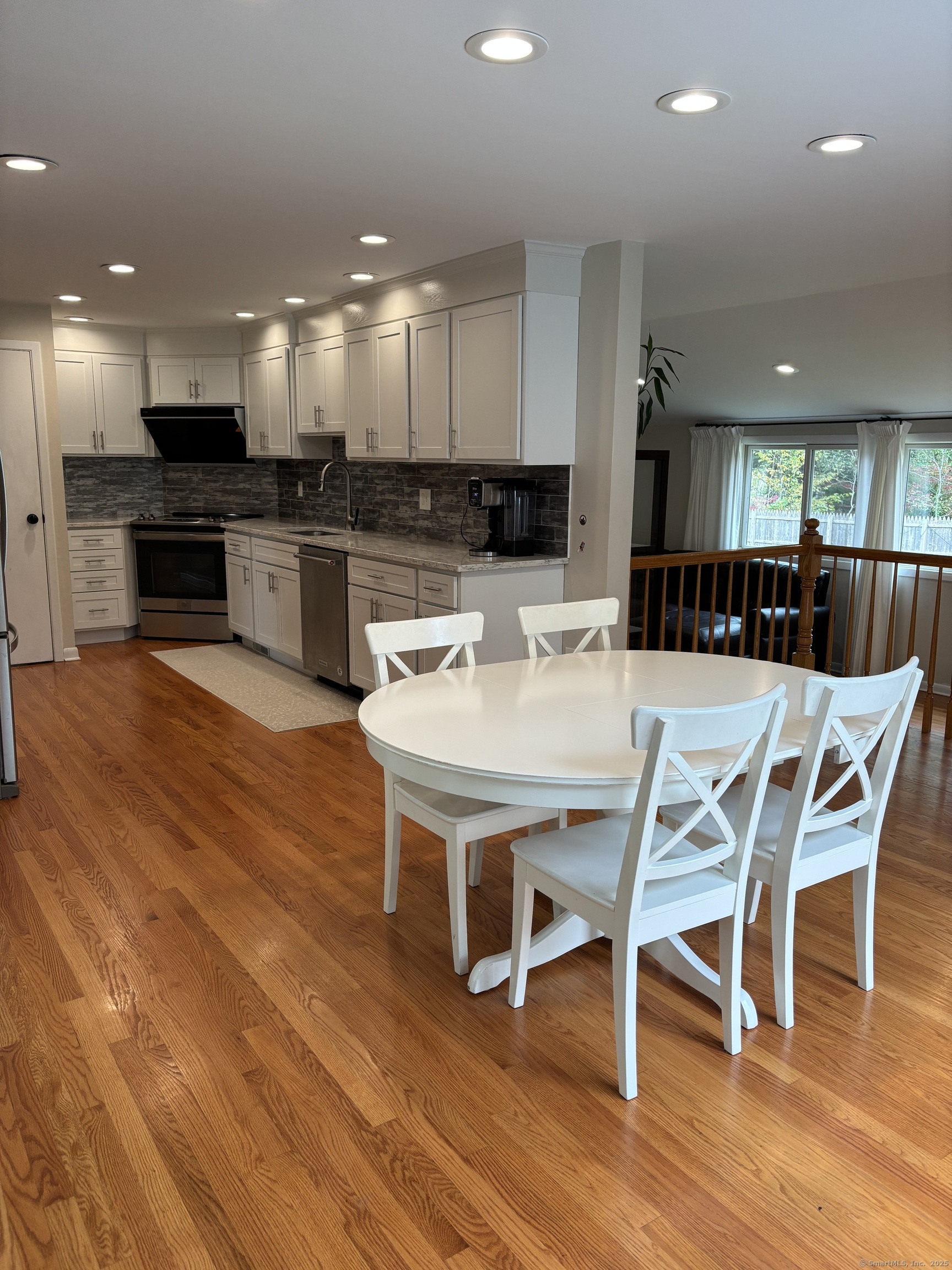 846 Beechwood Road Orange, CT 06477 - Photo 7 of 25 a view of a dining room with furniture wooden floor and kitchen view