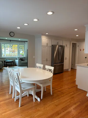a large kitchen with a table and chairs
