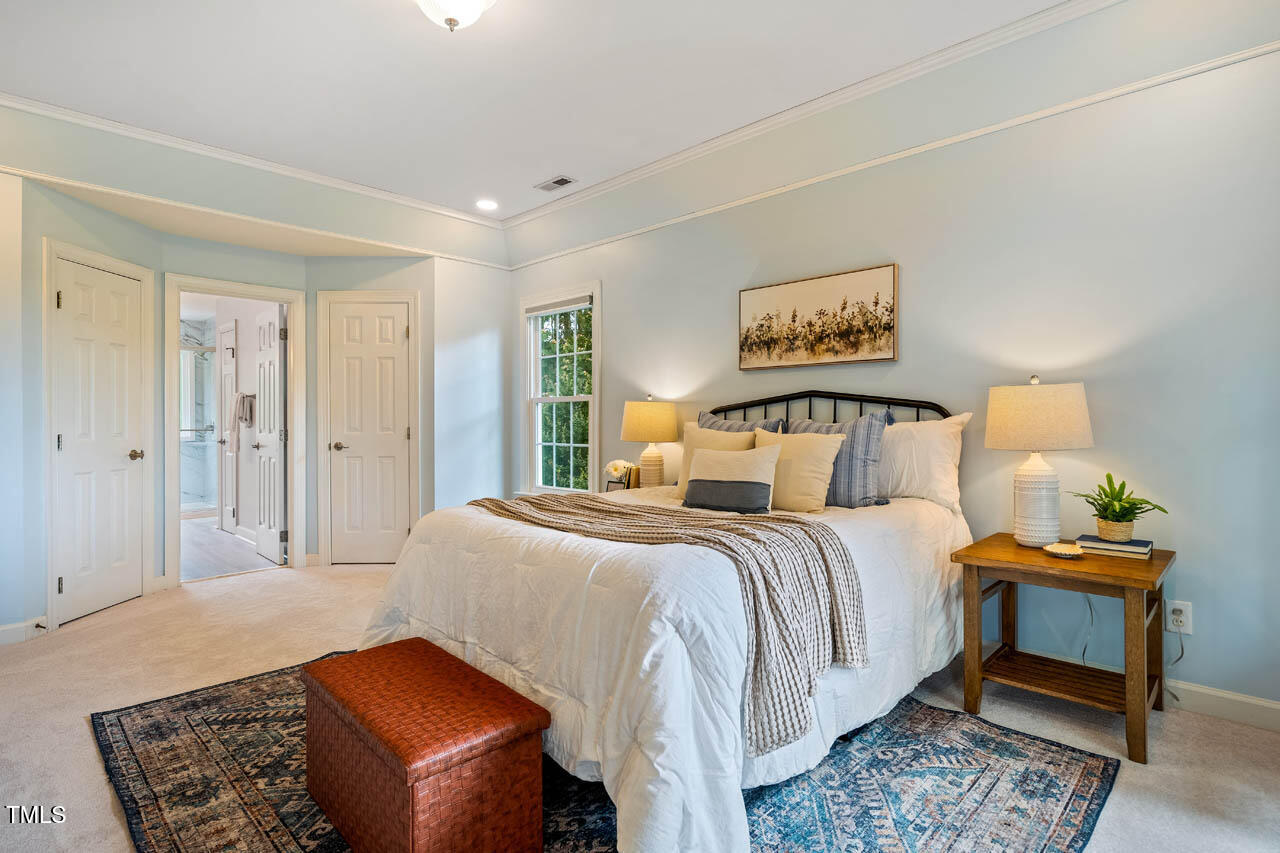 5205 Coffee Tree Drive Raleigh, NC 27613 - Photo 22 of 51 a bedroom with a bed and wooden floor