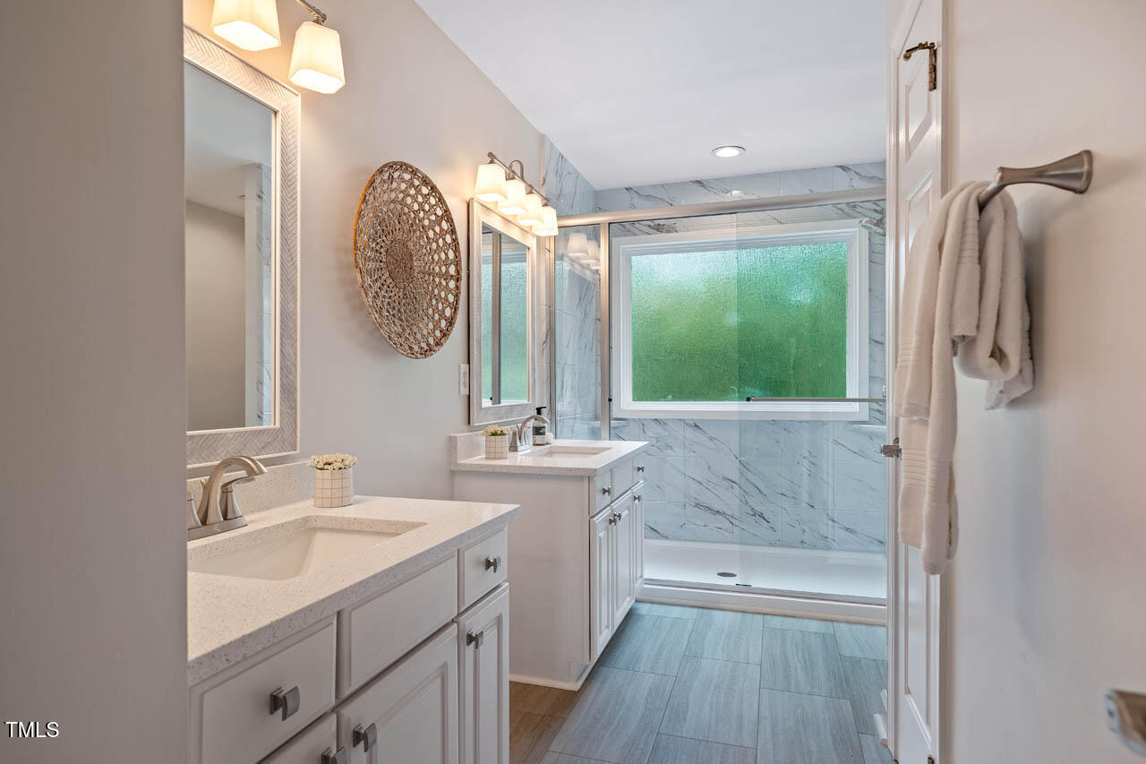 5205 Coffee Tree Drive Raleigh, NC 27613 - Photo 23 of 51 a bathroom with a double vanity sink mirror and shower