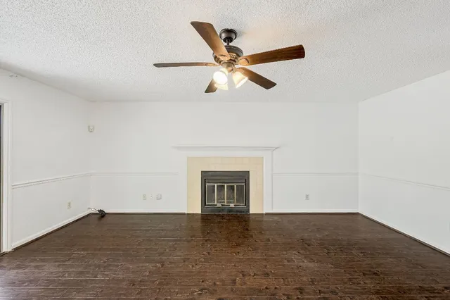 a room with a ceiling fan and a fireplace
