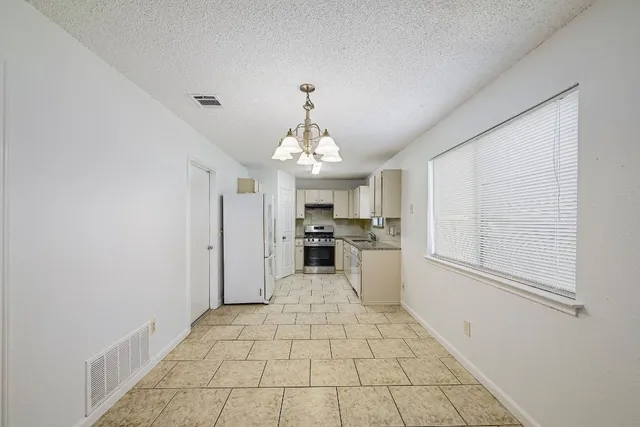 a view of a kitchen with microwave and cabinets