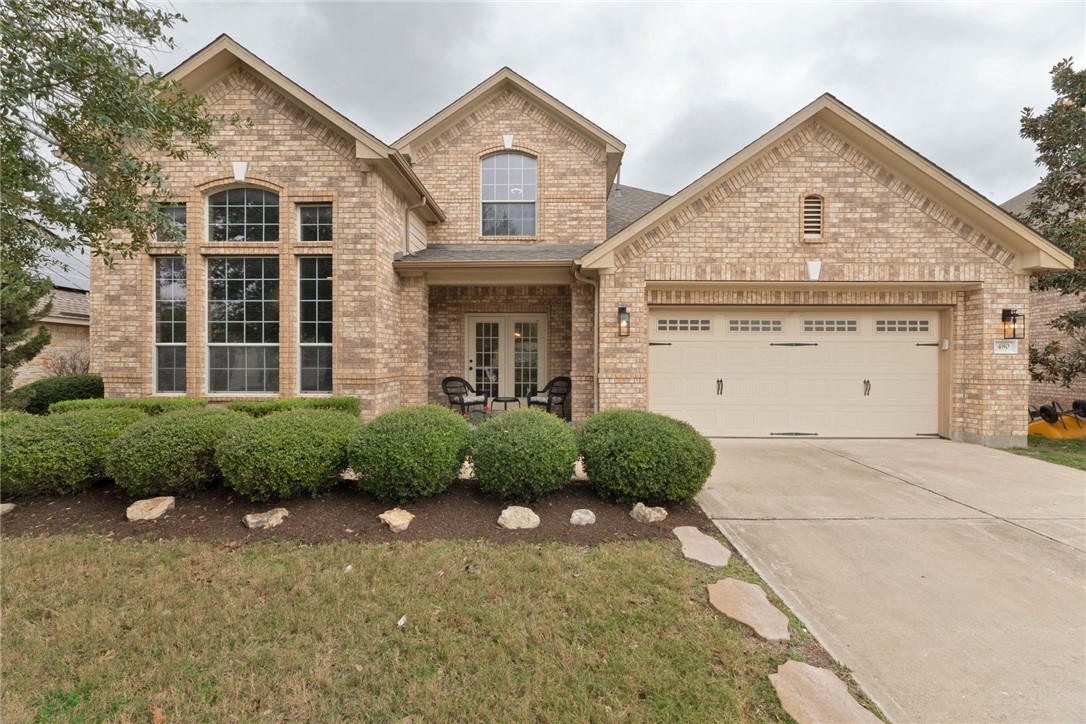 a front view of a house with garden