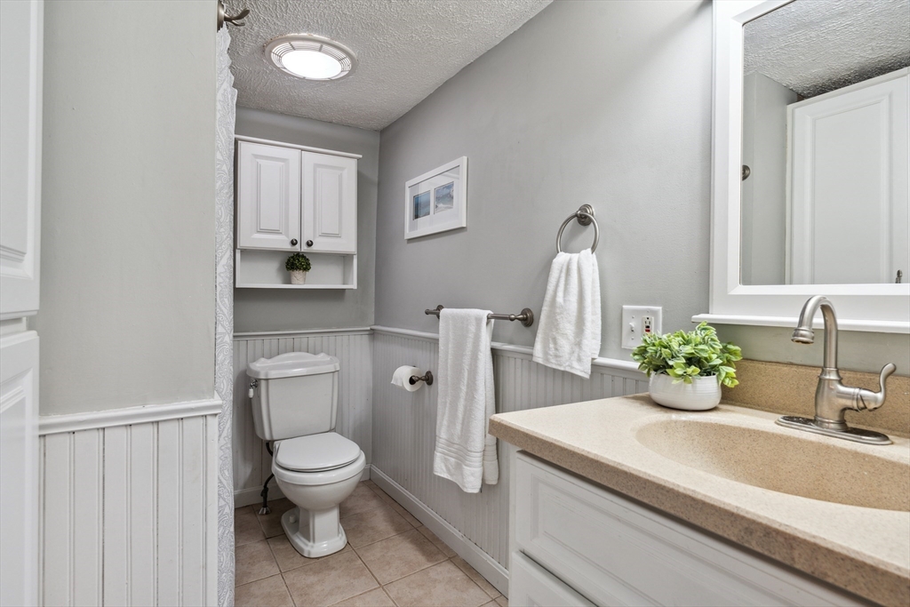 162 Proctor Road Chelmsford, MA 01824 - Photo 17 of 35 a bathroom with a toilet sink and mirror