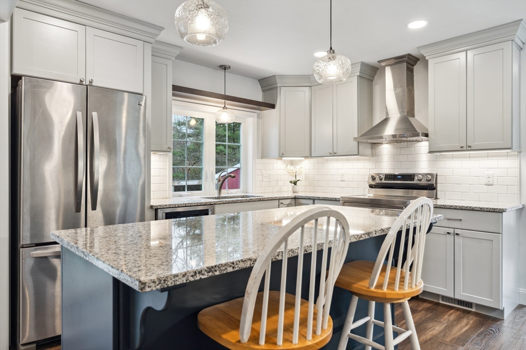 162 Proctor Road Chelmsford, MA 01824 - Photo 5 of 35 a kitchen with stainless steel appliances granite countertop a stove refrigerator and microwave