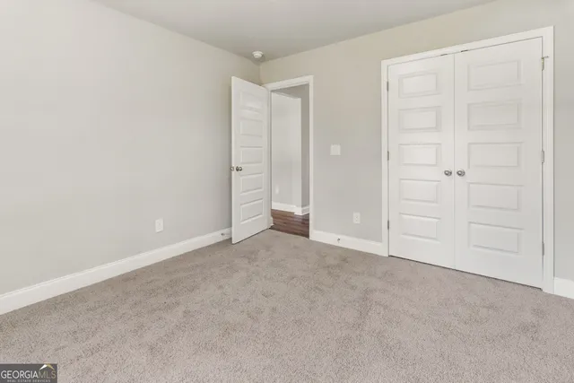 an empty room with closet area