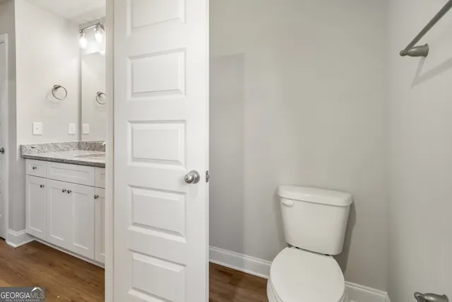a bathroom with a toilet sink and shower