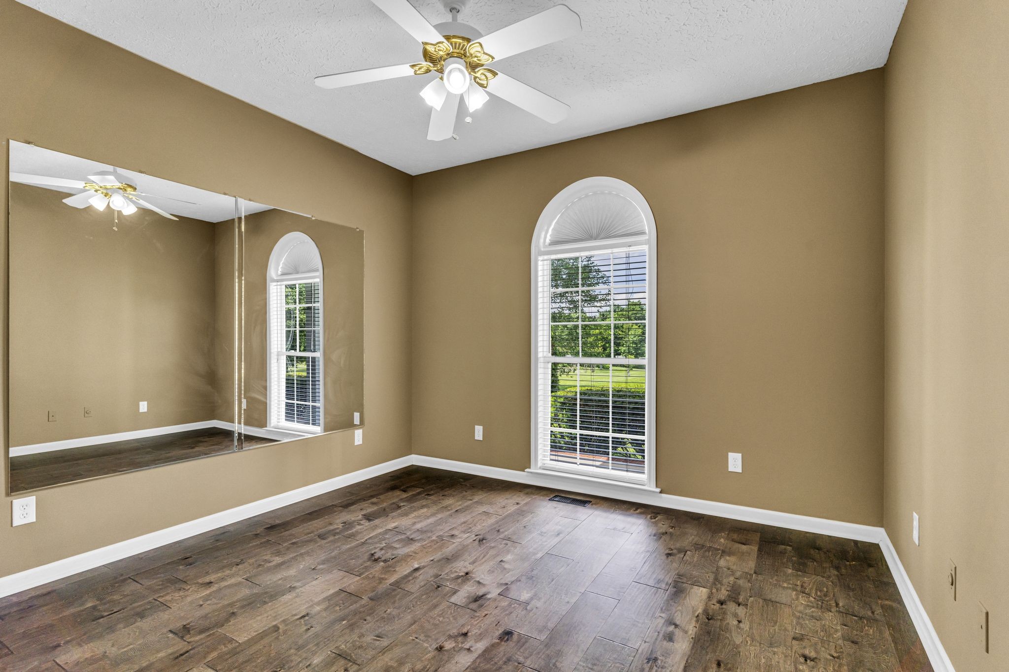 6689 East Benton Road Springfield, TN 37172 - Photo 26 of 44 an empty room with wooden floor and windows