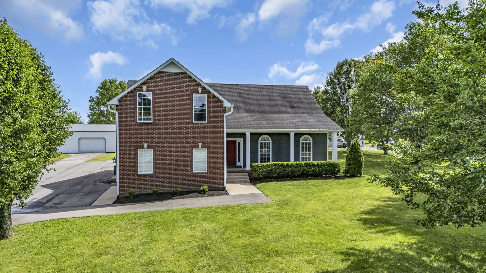 6689 East Benton Road Springfield, TN 37172 - Photo 5 of 44 a front view of a house with a yard and garage