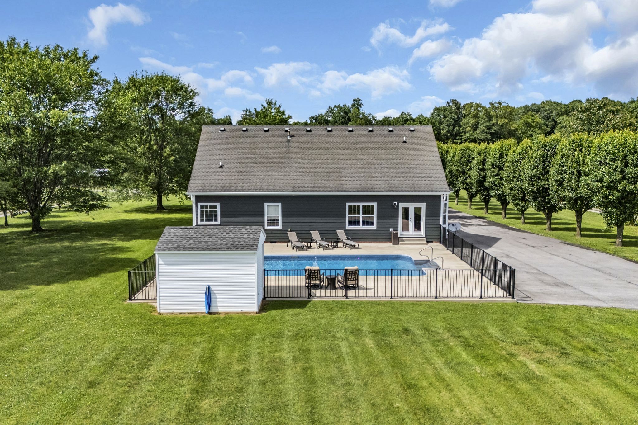 6689 East Benton Road Springfield, TN 37172 - Photo 6 of 44 a front view of a house with a garden and outdoor seating