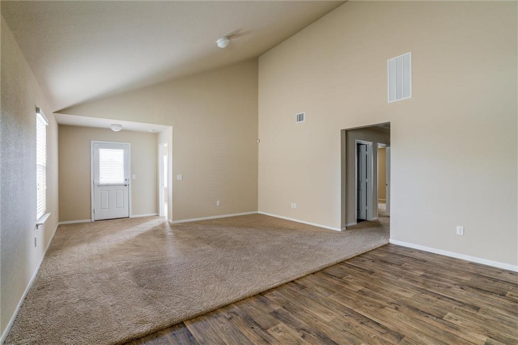 11704 Andesite Road Manor, TX 78653 - Photo 14 of 30 a view of an empty room with wooden floor and closet